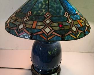 Lot 600: Ceramic table lamp on wooden base to include stained-glass shade, shade has damage; lamp measures 24 " high shade measures 20 " diameter