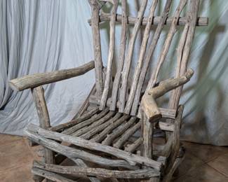 Lot 790: Artisan made branch armchair with over all measurements of 70 " high x 46 " wide