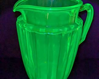 Lot 757: Uranium glass pitcher, sugar and creamer, shakers, cruet, juicer; pitcher measures 9 " high