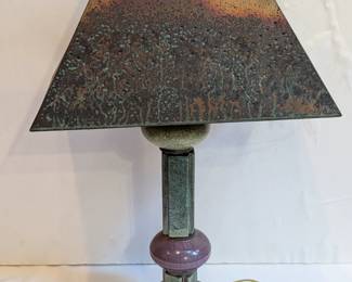 Lot 101: Artisan made pottery table lamp with punched copper shade, signed on bottom; measuring 29 " high