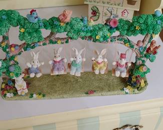 Ceramic bunnies' on swing
