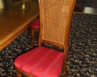 Dining table w/pads, 2 leaves, & 6 matching cane back chairs. Table: 112" L x 47"W x 30" T (w/leaves in). 72" L x 47" W x 36" T w/o leaves.