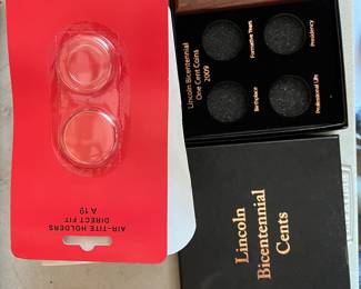 Box of new coin mounts. 