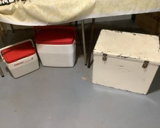 Two Coleman coolers and one vintage metal cooler