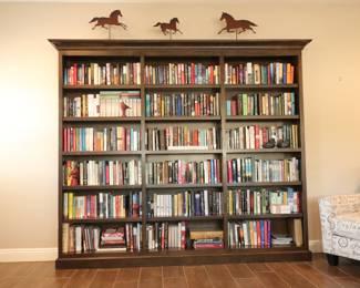 The bookshelf is fixed to the wall. It’s only the books for sale.