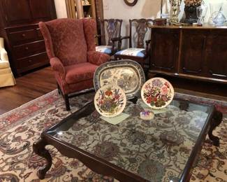 Wing back chair, beveled glass coffee table.