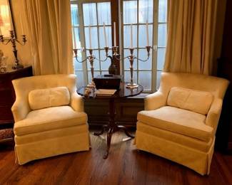 Pair of lovely stuffed arm chairs with antique tilt top table.  Pair of silver plate candelabras.