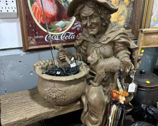 Molded Witch and her pot on bench.  Black Crows and Pumpkins