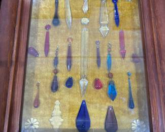 Wonderful antique prisims of all sizes and colors in shadow box.