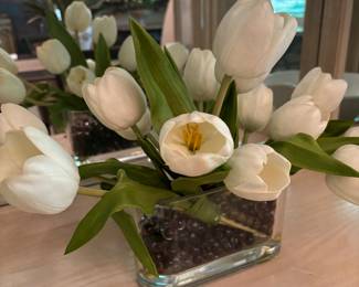 Always lovely tulips held in place by acrylic substance in glass vase.