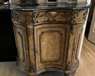 Country French with beautiful applique, painted with black inlaid stone top.  Cubbies inside of doors.  Notice the feet of this beautiful chest. 34"X16"X36"