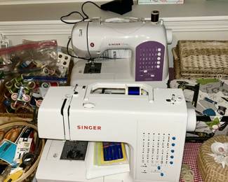 Two Singer sewing machines, misc. sewing supplies, thread, etc.