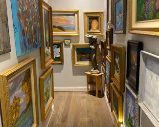 Gallery hallway full of fun folk art in super cool frames by Diane Rowland.