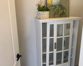 White cabinet with sliding doors.
