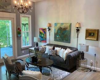 Living room features soft leather couch and French accent chairs.