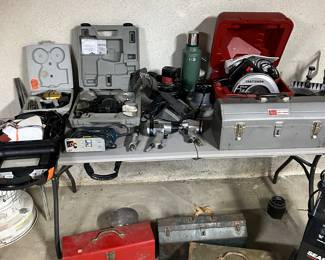 table of drills all for sale and tools with toolboxes full of tools