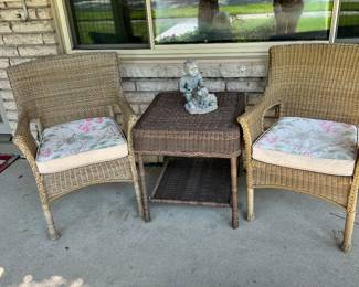 2 wicker chairs with cushions and wicker table