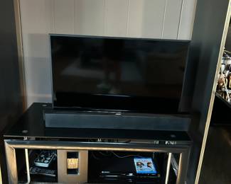 Roku Hi sense tv, Glass entertainment center, matching cario cabinets