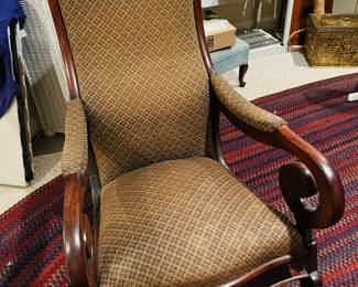 Antique scrolled arm rocking chair