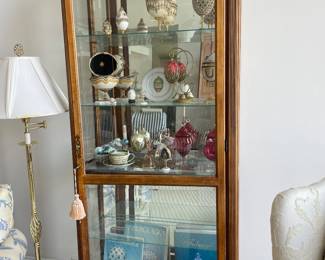 Tall curio cabinet by Howard Miller (some of the contents have been sold)