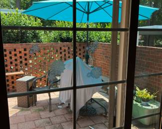Outdoor furniture -glass-topped metal table; metal chairs
