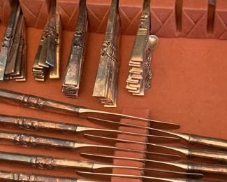 Multiple sets of silver flatware and silver serving pieces