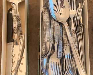 Multiple sets of silver flatware and silver serving pieces