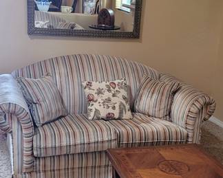 Very nice striped velour loveseats. Antique coffee table wth fold out extensions 