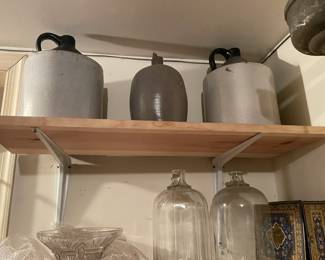 Vintage crocks and jug handle bottles.