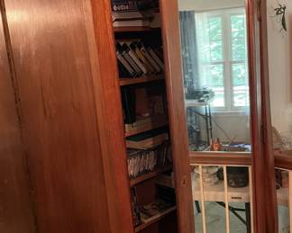 Armoire with CDs, DVDs and record albums.