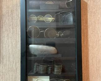 Shadow box with vintage eye glasses.