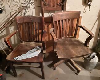 Vintage wooden swivel desk chairs.