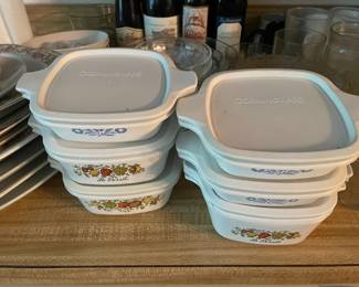Small corning ware containers with lids.