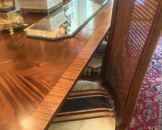 One of the 8 cane-back chairs