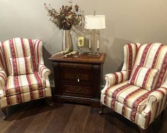 Upholstered wingback chairs; side table