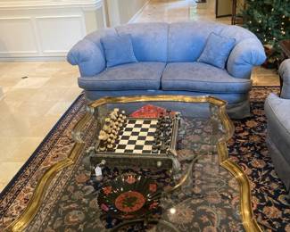 Settee and glass top brass coffee table