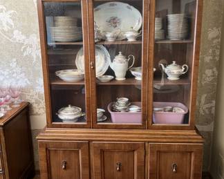 This china cabinet is for sale, as is the china set inside.