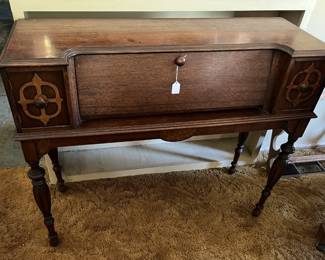 This piece is a desk, with a certain elegance associated with it.