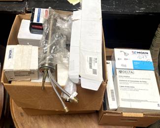 Box of all of the plumbing fixtures - bathroom and kitchen things