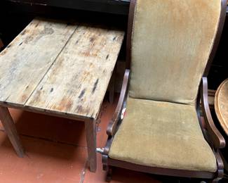 Another antique wooden table and upholstered rocking chair