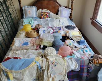 Beautiful bed frame and bed. Lots of vintage hats, scarves and doilies.