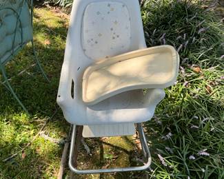 Outdoors in back of the house - vintage high chair