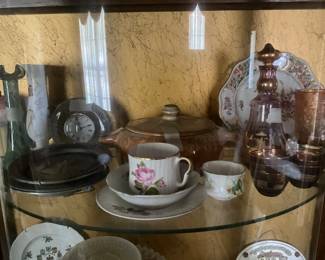 Collectibles in maple curio cabinet