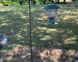 Outdoors in back of the house - shepherd hook & bird feeder