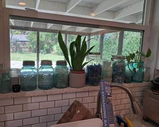 Window full of blue Ball jars and seaglass