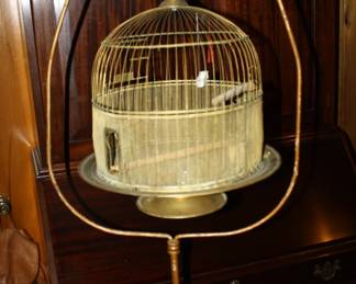 There are about 10 vintage bird cages on stands