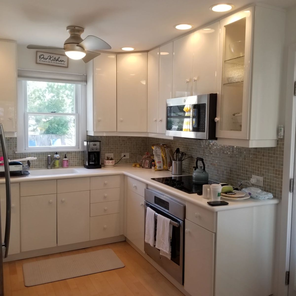 Cute contemporary kitchen cabinets - white laminate. GE microwave oven mfg. May 2022