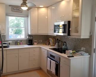 Cute contemporary kitchen cabinets - white laminate. GE microwave oven mfg. May 2022