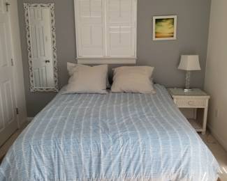 Queen bed; white wicker nightstand
