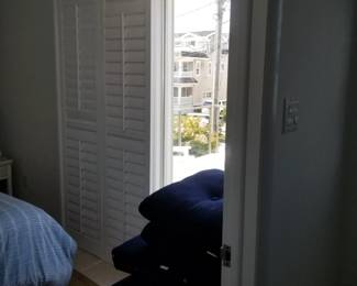 Plantation shutters for sliding glass doors